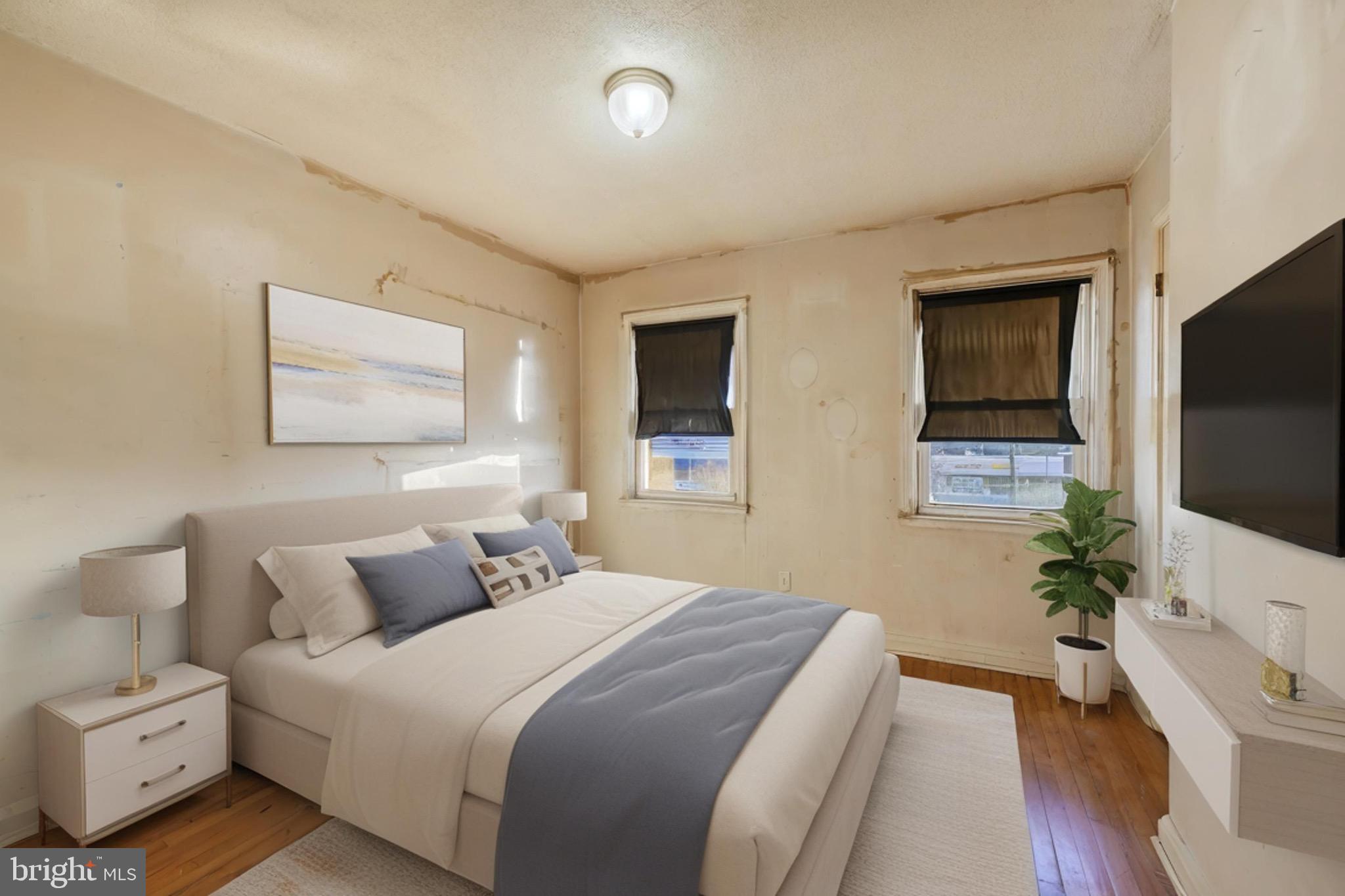 414 Kane Street Baltimore, MD 21224 - Photo 5 of 15 a bedroom with a bed and a flat screen tv