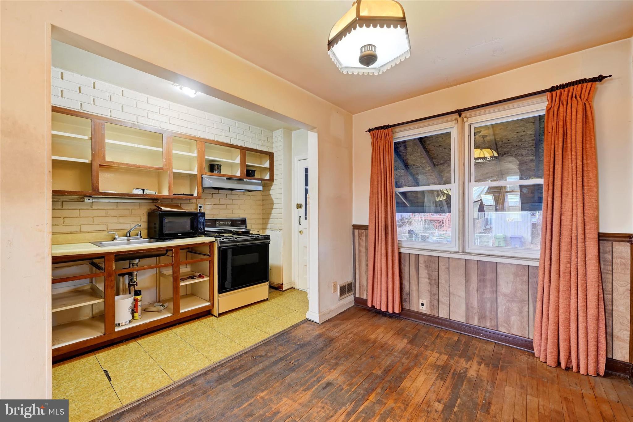 414 Kane Street Baltimore, MD 21224 - Photo 9 of 15 a kitchen with stainless steel appliances granite countertop a stove and a refrigerator