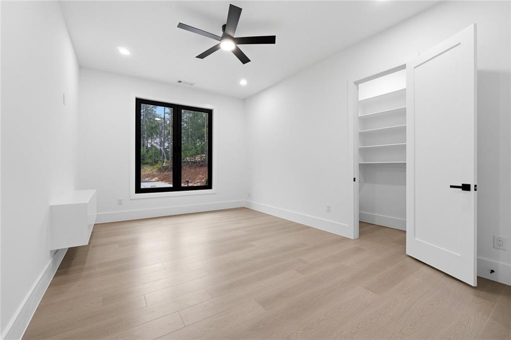 1563 Whitley Road Dacula, GA 30019 - Photo 25 of 44 wooden floor in an empty room with a window
