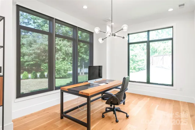 a view of a room with lounge chair and windows