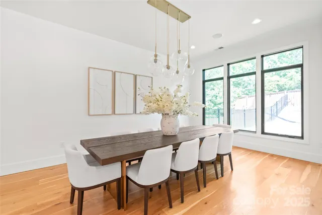 a view of a dining room with furniture and a large window
