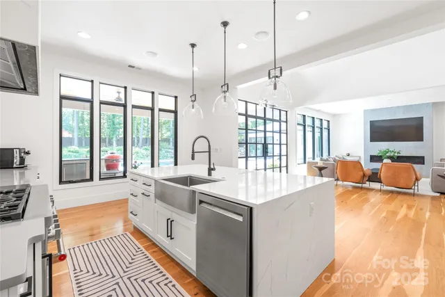 a large white kitchen with a large window