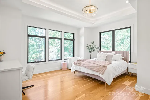 a spacious bedroom with a large bed and a large window