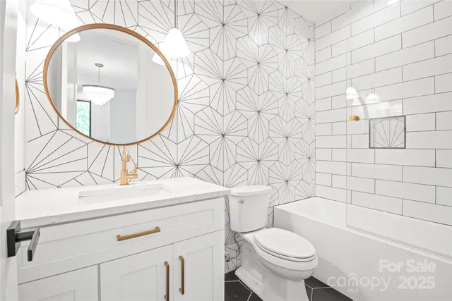 a bathroom with a sink toilet and a mirror