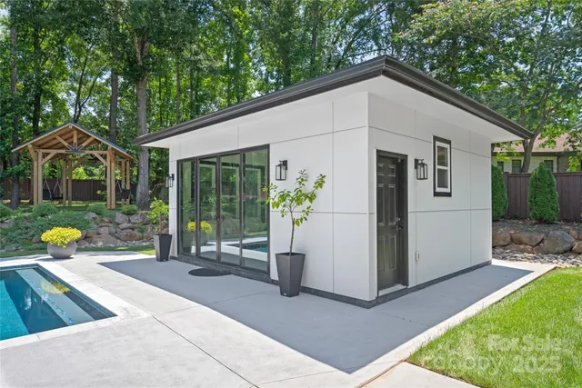a view of a house with swimming pool and porch with furniture