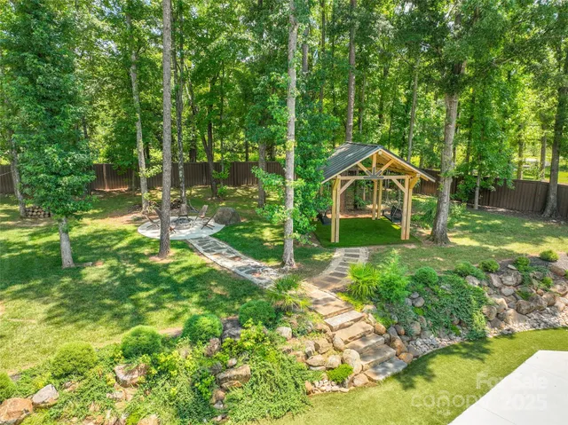 a front view of a house with swimming pool and porch