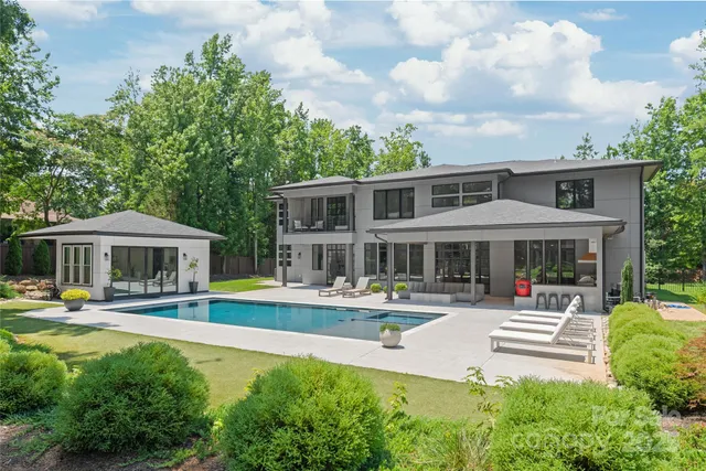an aerial view of a house with garden space and street view