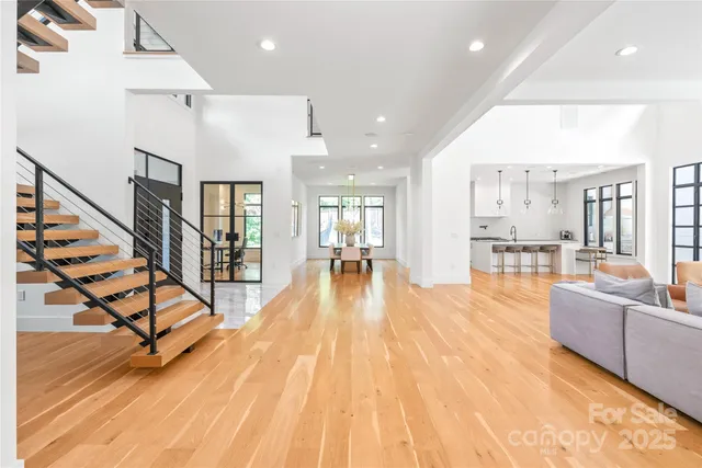 a view of a living room and kitchen with furniture wooden floor