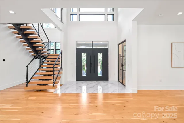 a view of entryway and hall with wooden floor