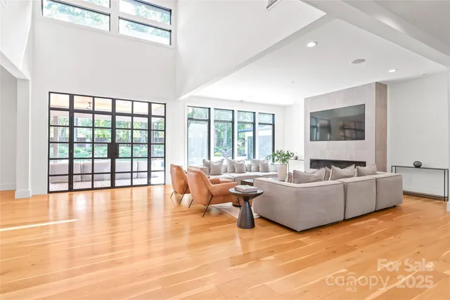 a living room with furniture and large windows