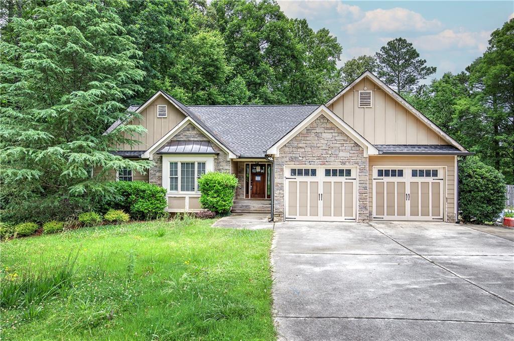 561 Holland Road Dallas, GA 30157 - Photo 1 of 48 a front view of a house with a garden and yard