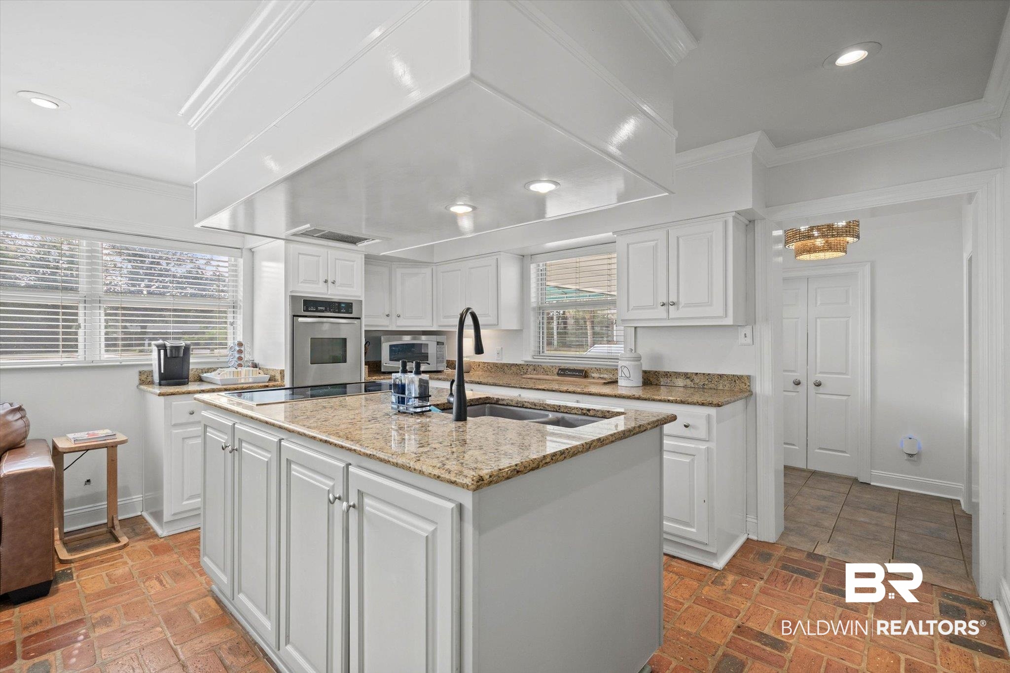 3720 Rabbit Creek Court Theodore, AL 36582 - Photo 8 of 47 Kitchen with white cabinetry, light stone counters, ornamental molding, stainless steel oven, and a kitchen island with sink