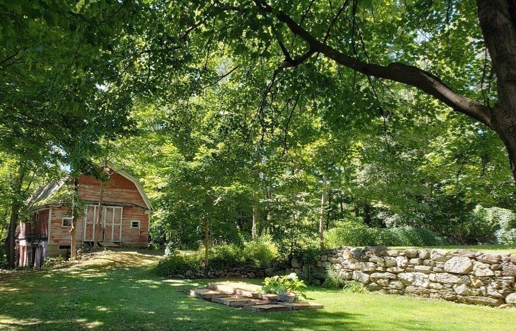 4 Pleasant Street Huntington, MA 01050 - Photo 18 of 38 a large tree in front of a house with a yard