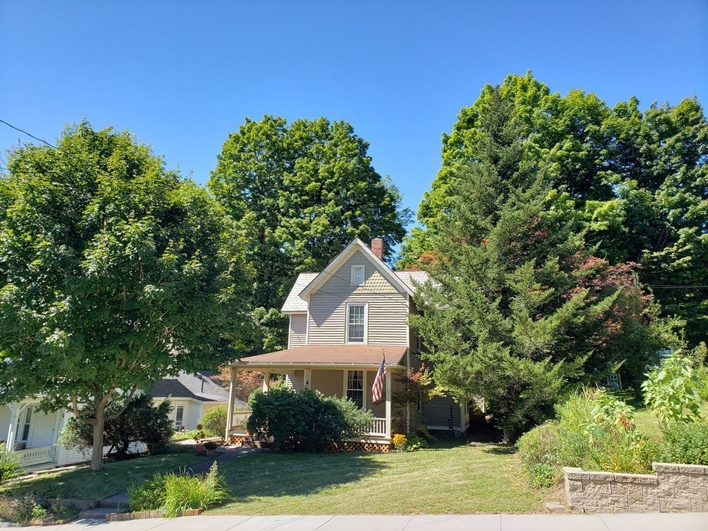 4 Pleasant Street Huntington, MA 01050 - Photo 2 of 38 a front view of a house with a garden