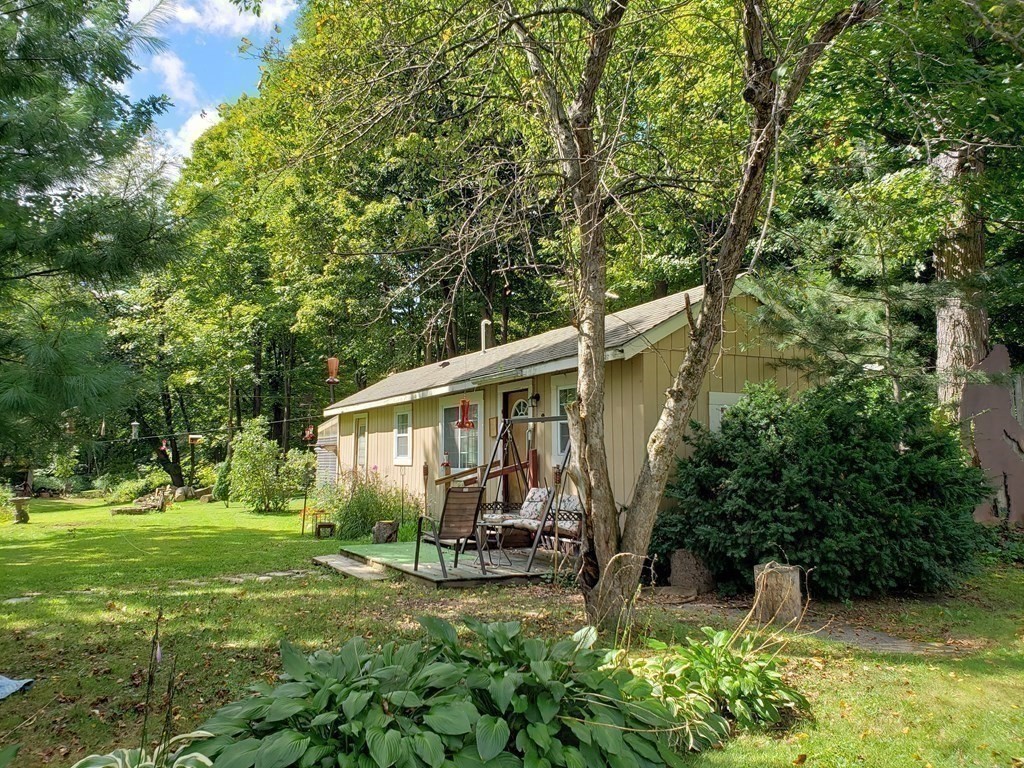 4 Pleasant Street Huntington, MA 01050 - Photo 25 of 38 a backyard of a house with table and chairs with plants