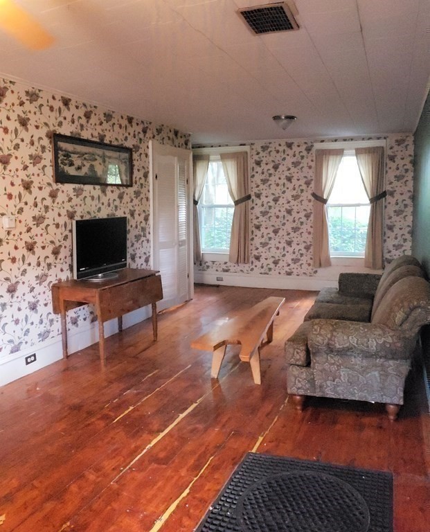 4 Pleasant Street Huntington, MA 01050 - Photo 31 of 38 a living room with furniture and a flat screen tv