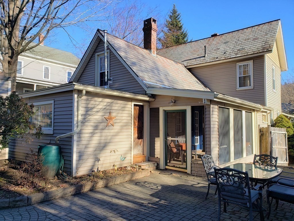 4 Pleasant Street Huntington, MA 01050 - Photo 4 of 38 a view of a patio with table and chairs and wooden floor