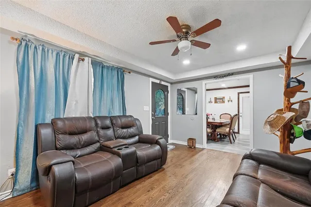 a work room with furniture and a ceiling fan