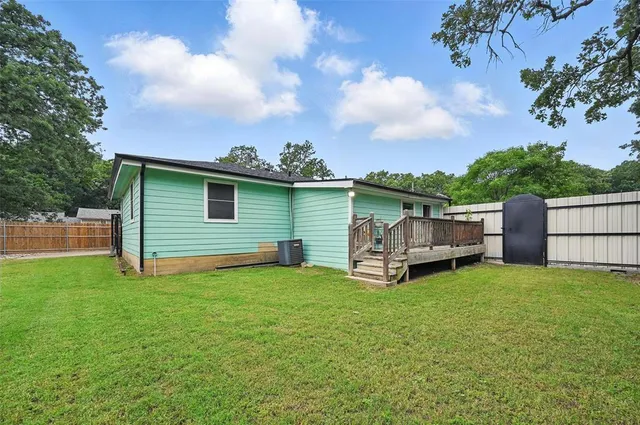 a view of a house with a yard and sitting area