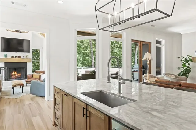 a kitchen with furniture a large window and a fireplace