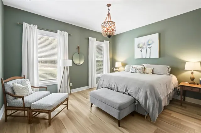 a spacious bedroom with a bed and a window