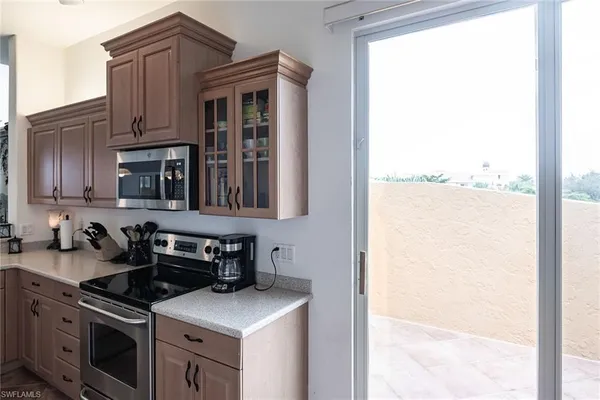 a kitchen with stainless steel appliances granite countertop a stove and a refrigerator