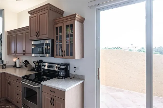 a kitchen with stainless steel appliances granite countertop a stove and a refrigerator