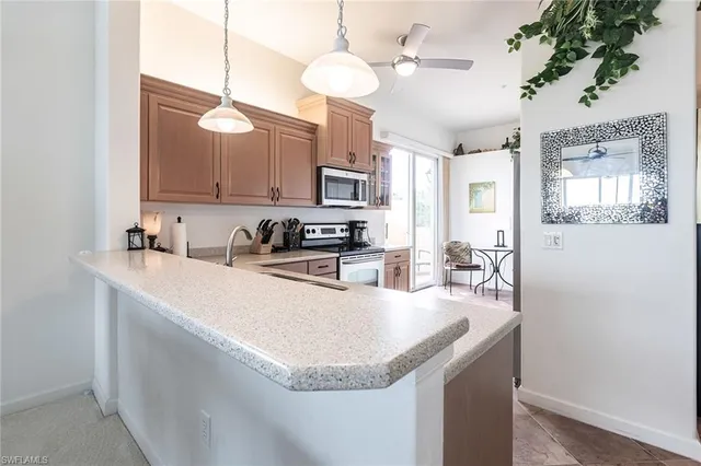 a kitchen with stainless steel appliances granite countertop a sink a stove and a refrigerator