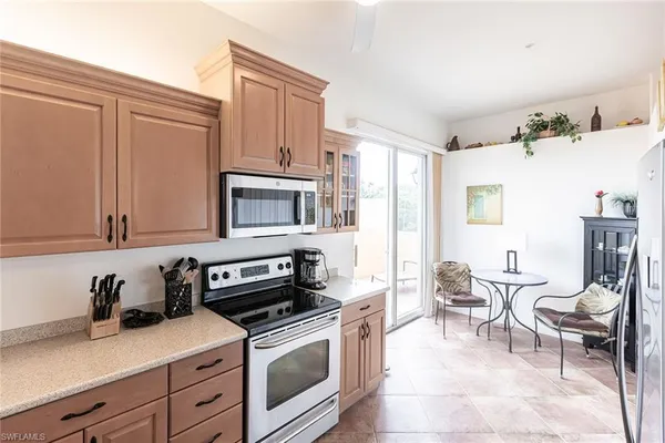 a kitchen with stainless steel appliances a stove a sink cabinets and a window