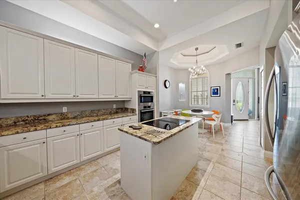 a kitchen with stainless steel appliances granite countertop a refrigerator sink and stove
