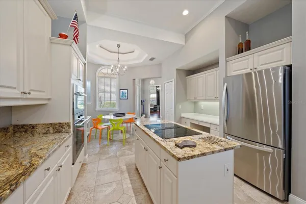 a kitchen with granite countertop a sink stove and cabinets