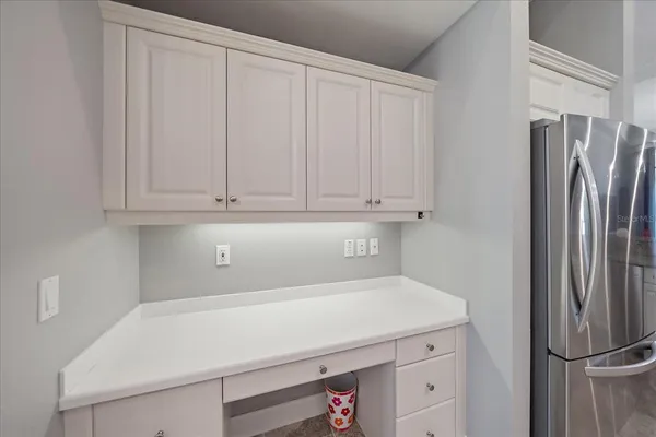 a living room with furniture kitchen and a chandelier