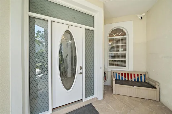a spacious bedroom with a large bed and a chandelier