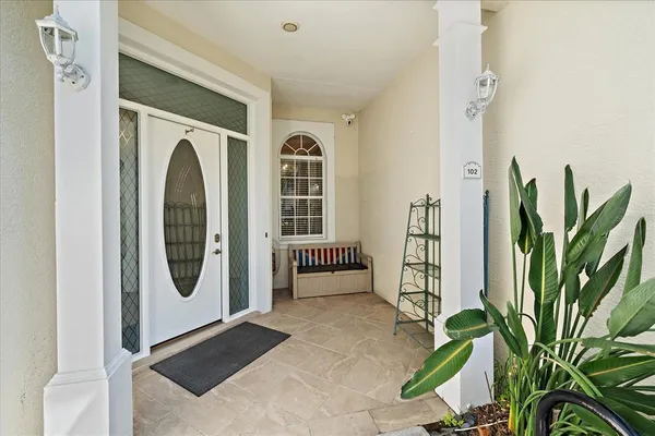 a kitchen with a dining table chairs stainless steel appliances and cabinets