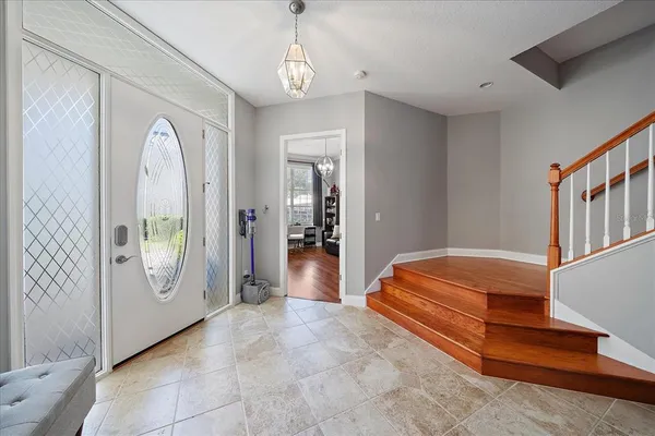 a view of a dining room with furniture and chandelier