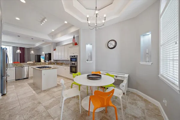 a kitchen with stainless steel appliances white cabinets sink and stove