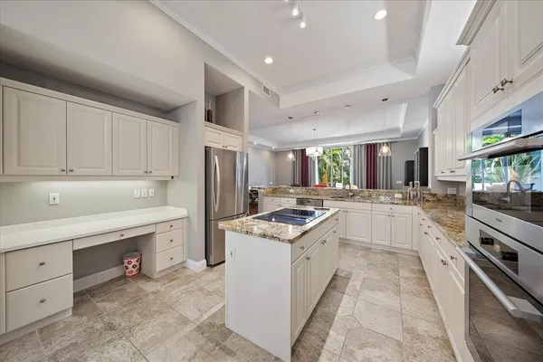 a bathroom with a granite countertop sink and a large mirror