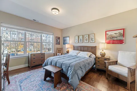 a bedroom with a large bed and a couch