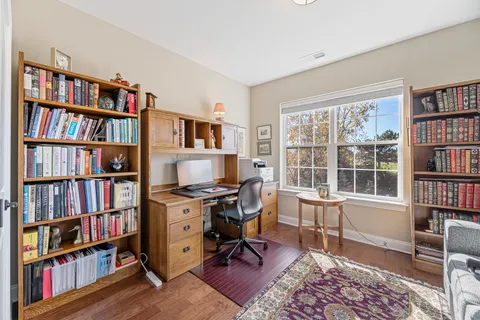 a view of a livingroom with a bookshelf and a window