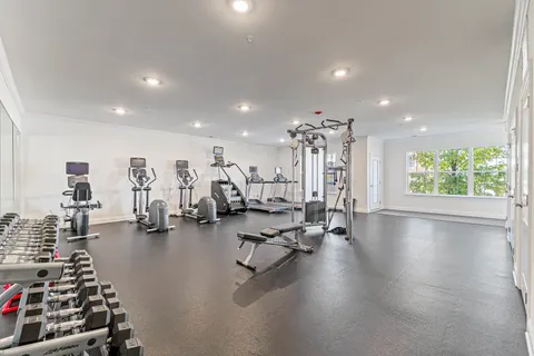 a view of a room with gym equipment and a large window