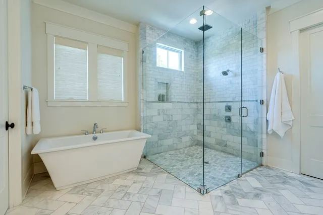 a spacious bathroom with a shower and bathtub