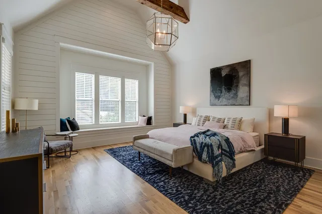 a living room with a bed furniture and a flat screen tv