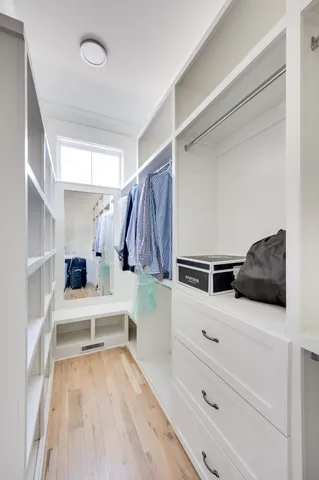 a kitchen with a refrigerator and white cabinets
