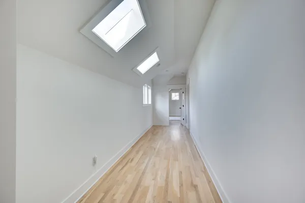 a view of a hallway with wooden floor