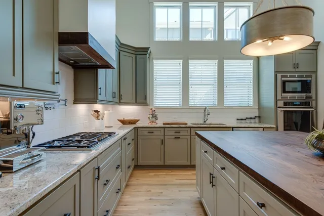a kitchen with granite countertop a stove sink and cabinets