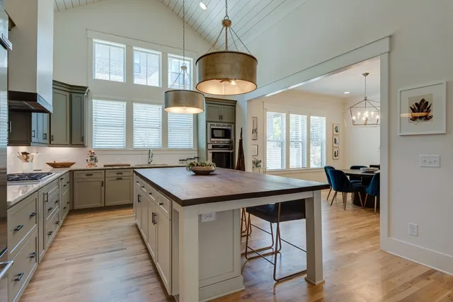 a kitchen with cabinets and wooden floor