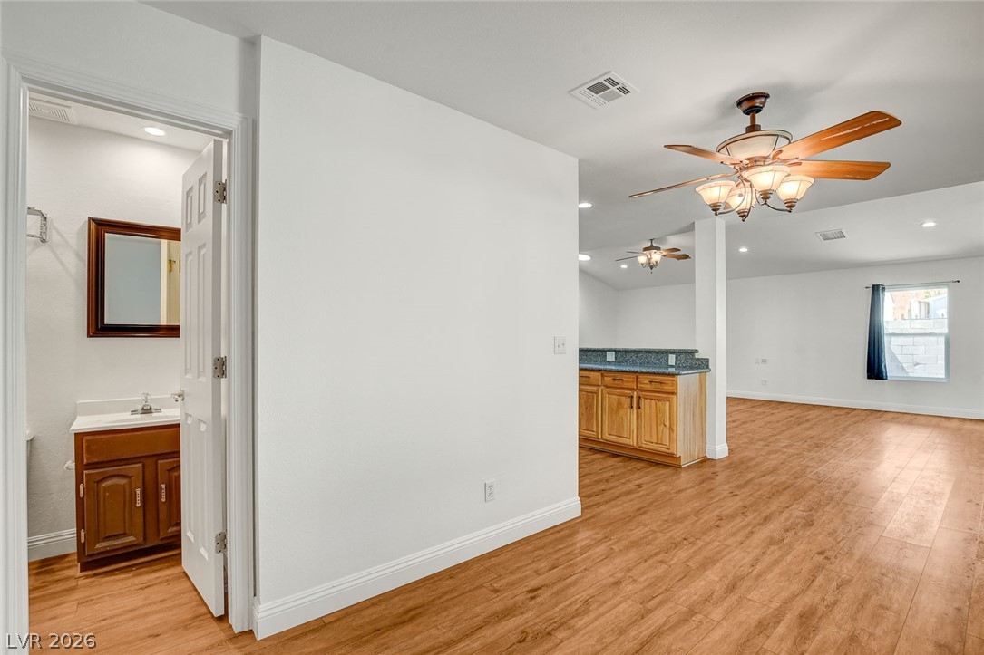 1810 Pinto Road Henderson, NV 89002 - Photo 25 of 53 A versatile open-concept space featuring rich wood flooring and a convenient wet bar.