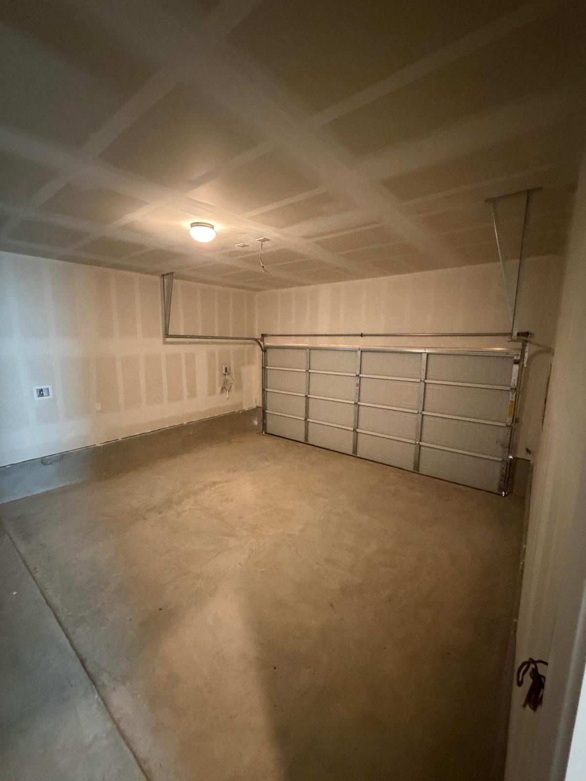 2612 Towy Road Manor, TX 78653 - Photo 10 of 35 A spacious, newly finished garage offering ample room for vehicles and storage.