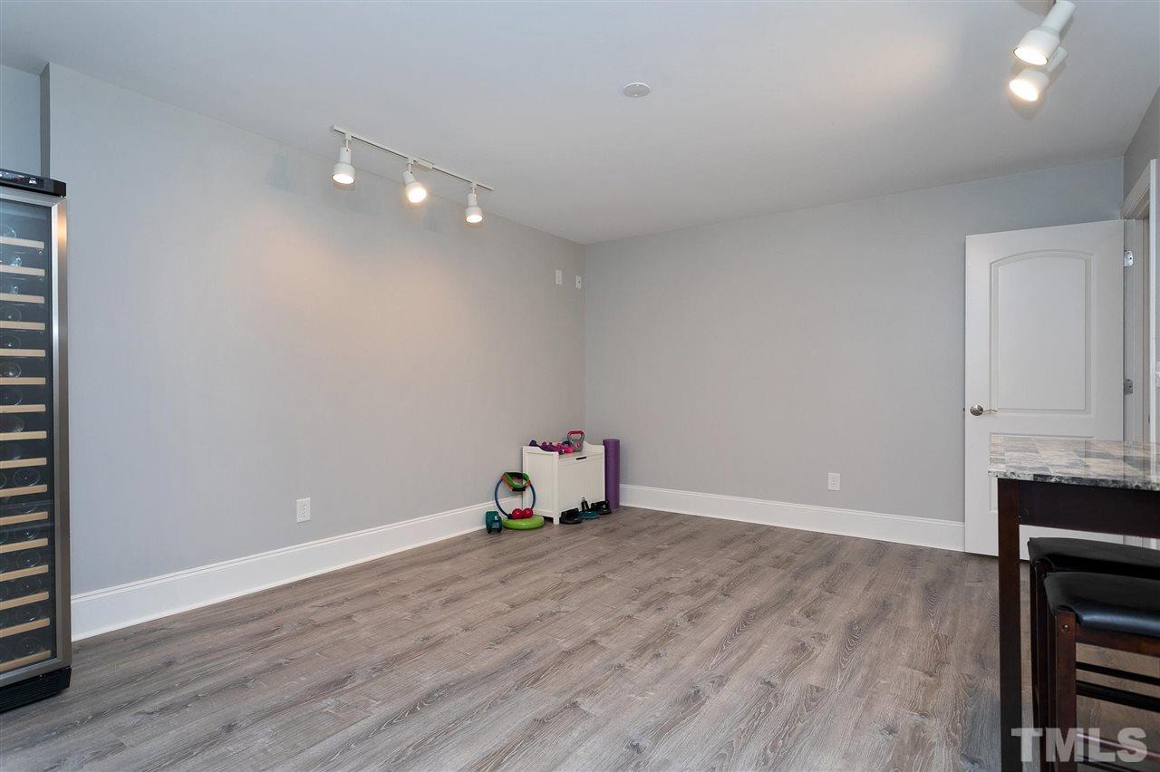 2521 Hunters Meadow Lane Raleigh, NC 27606 - Photo 23 of 30 an empty room with wooden floor and cabinet