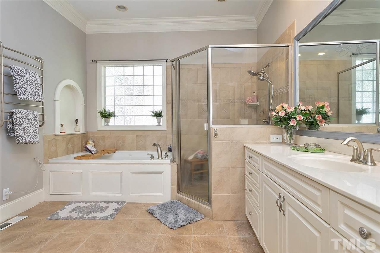 2521 Hunters Meadow Lane Raleigh, NC 27606 - Photo 6 of 30 a bathroom with a tub sink and mirror